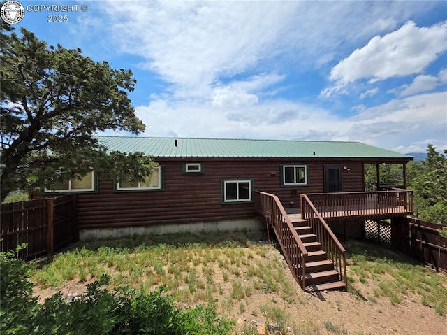 612 Lowry Ln, Canon City, CO 81212 - back of property with a deck, stairway, log veneer siding, and a metal roof