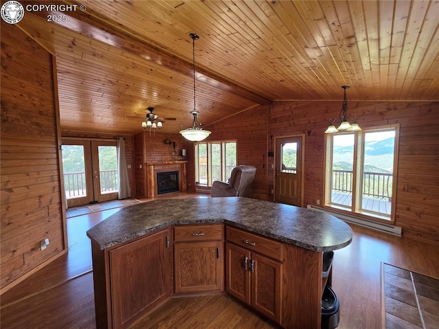 612 Lowry Ln, Canon City, CO 81212 - kitchen with dark countertops, wooden ceiling, wood walls, open floor plan, and dark wood-type flooring