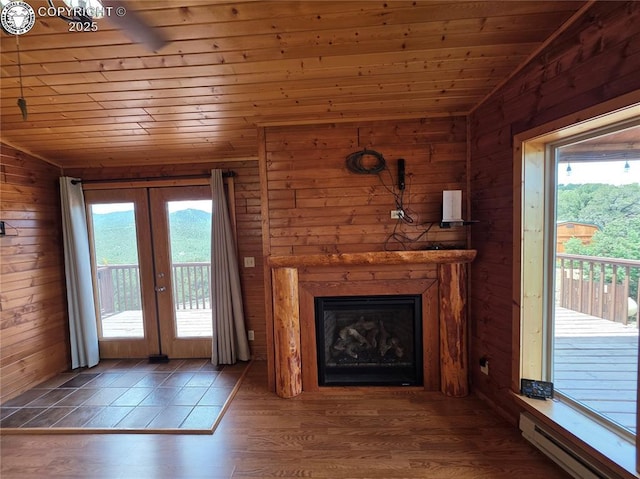 612 Lowry Ln, Canon City, CO 81212 - unfurnished living room featuring lofted ceiling, a baseboard radiator, wood ceiling, french doors, and wooden walls