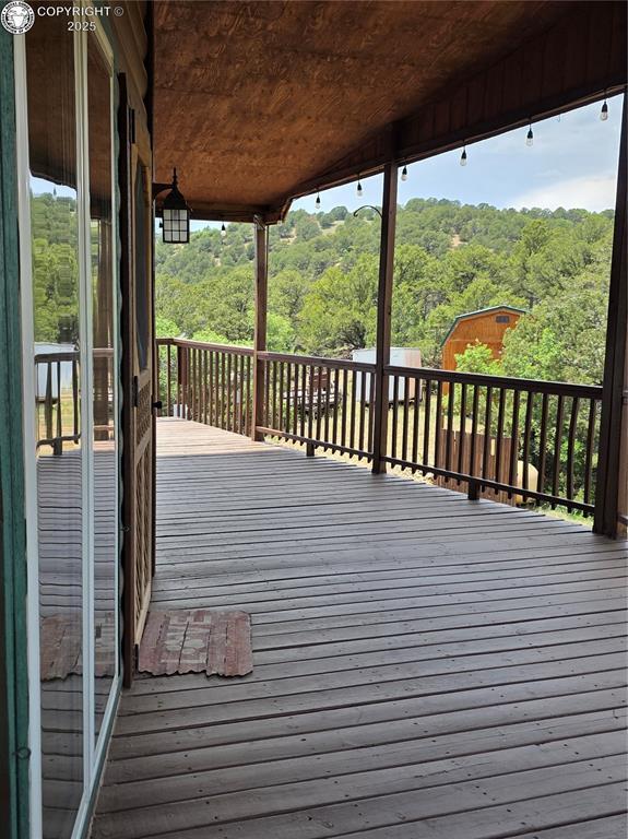 612 Lowry Ln, Canon City, CO 81212 - wooden deck featuring a view of trees