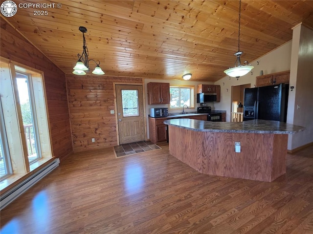 612 Lowry Ln, Canon City, CO 81212 - kitchen with black appliances, baseboard heating, vaulted ceiling, wooden ceiling, and dark countertops
