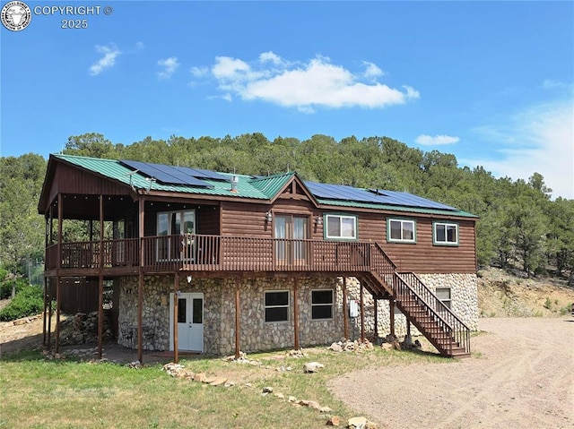 612 Lowry Ln, Canon City, CO 81212 - view of front of home with french doors, a wooden deck, and stone siding