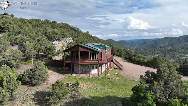 612 Lowry Ln, Canon City, CO 81212 - back of house with a deck with mountain view, a wooded view, stairs, and stone siding
