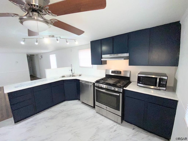 kitchen featuring blue cabinetry, appliances with stainless steel finishes, and sink