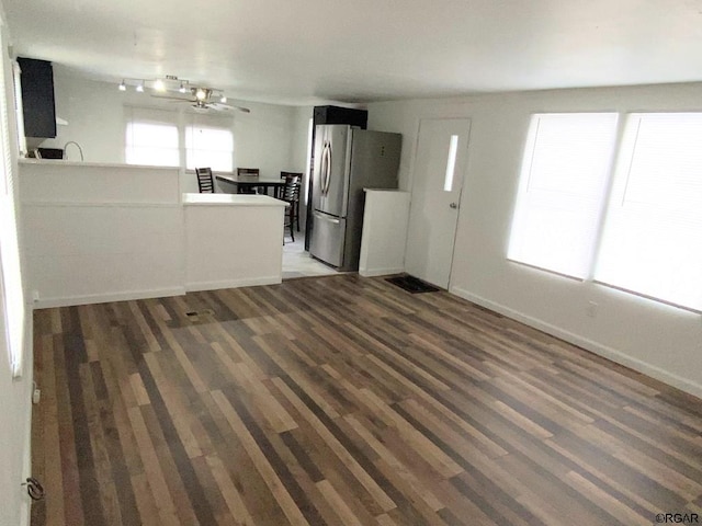 kitchen with dark hardwood / wood-style floors and stainless steel fridge