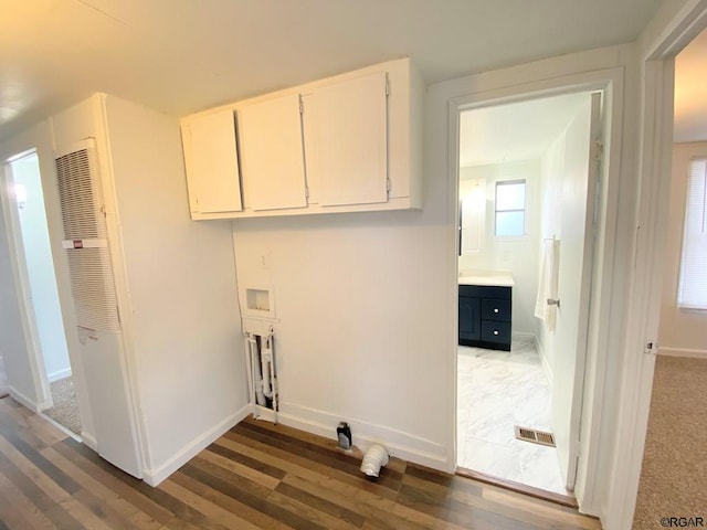 washroom with cabinets, washer hookup, and dark hardwood / wood-style floors