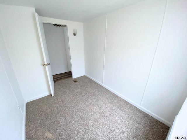 unfurnished bedroom featuring carpet floors and a closet