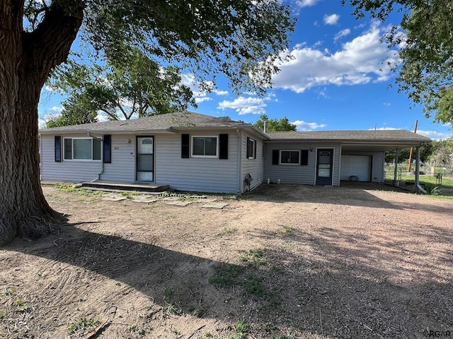 single story home featuring a garage and a carport