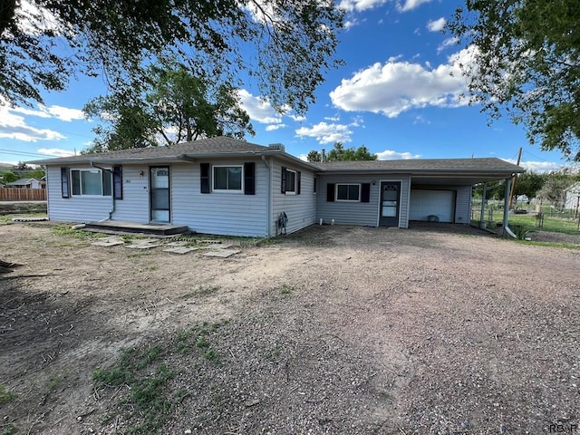 single story home featuring a garage and a carport