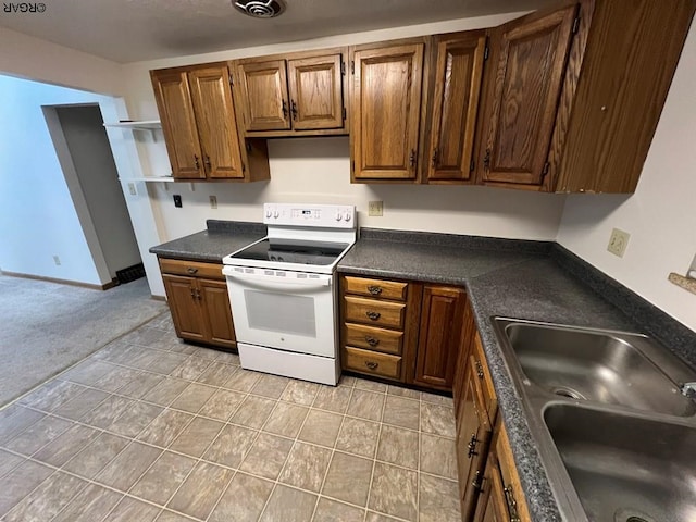 kitchen featuring sink, light tile patterned floors, and white range with electric stovetop