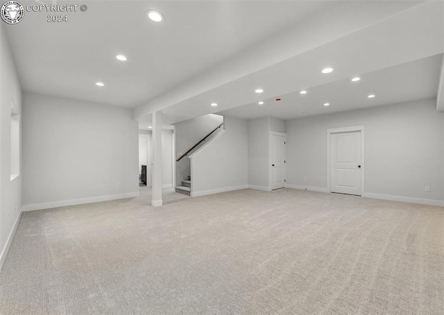 basement featuring light colored carpet