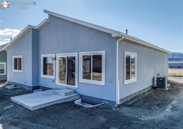 back of property featuring a patio and central air condition unit