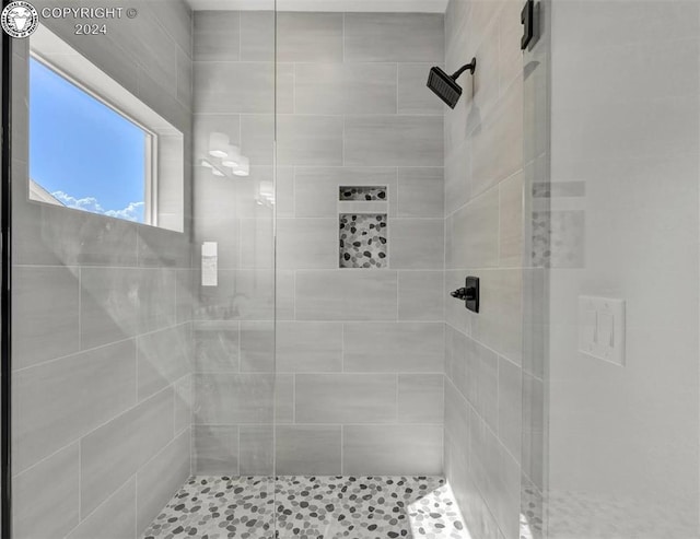 bathroom with a tile shower