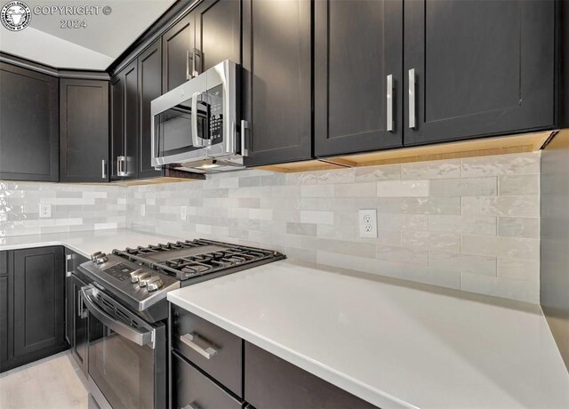 kitchen with backsplash and stainless steel appliances