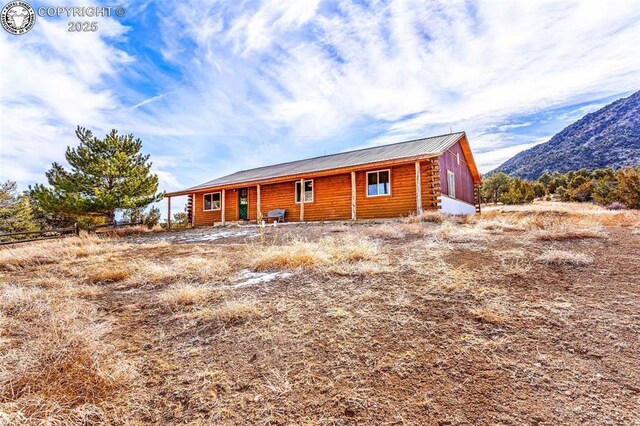 rear view of house featuring a mountain view