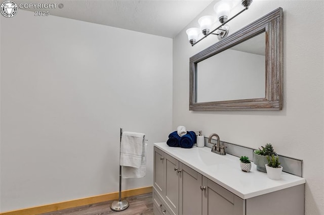 bathroom with vanity and hardwood / wood-style floors