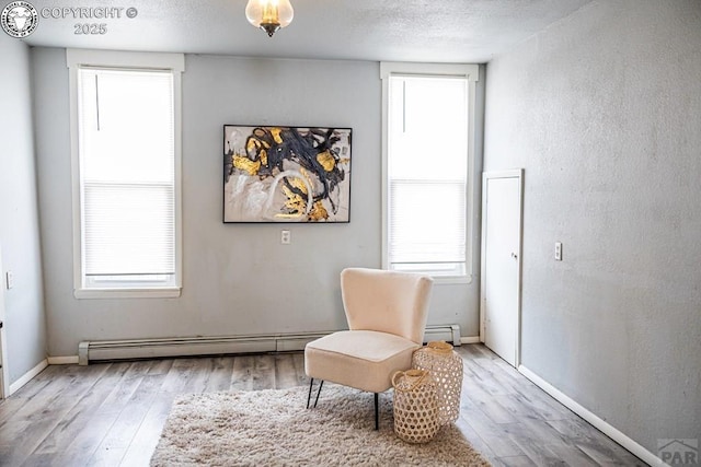 2723 3rd Ave, Pueblo, CO 81003 - sitting room with a wealth of natural light, wood finished floors, baseboards, and a baseboard heating unit
