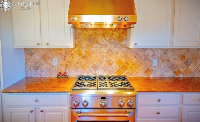 kitchen with white cabinets, gas range, and range hood