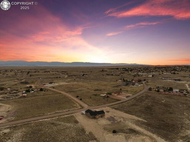 aerial view at dusk featuring a mountain view