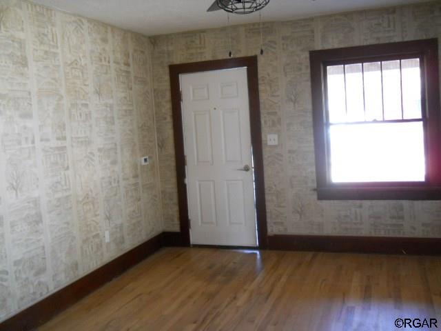 empty room with hardwood / wood-style floors