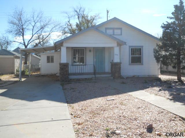 view of front of house with a porch and a carport