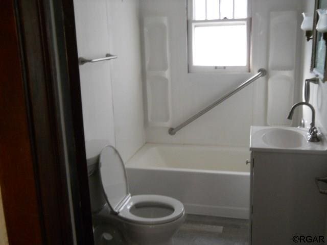 full bathroom with vanity,  shower combination, and toilet