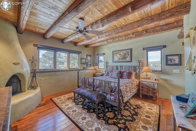 bedroom featuring hardwood / wood-style flooring, ceiling fan, beam ceiling, and wooden ceiling