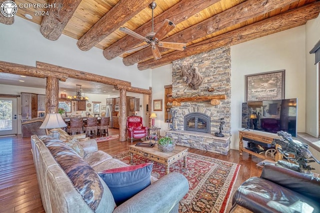 living room with hardwood / wood-style floors, beam ceiling, decorative columns, a fireplace, and wooden ceiling