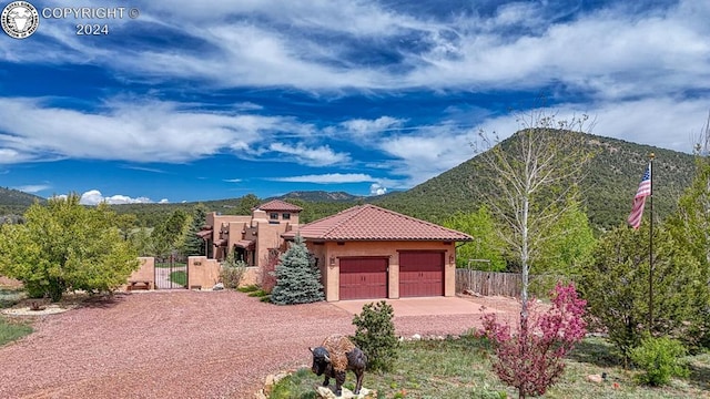 view of front of house featuring a mountain view and a garage