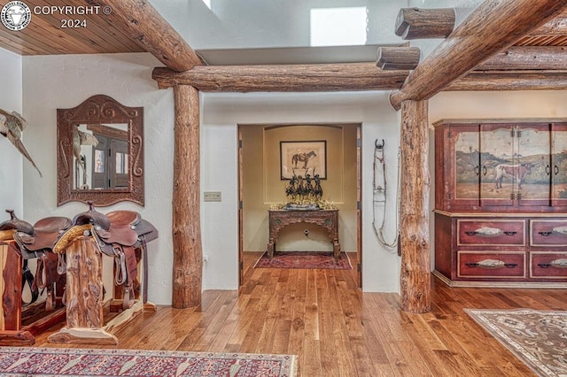 hall with beamed ceiling, wood ceiling, and light hardwood / wood-style flooring