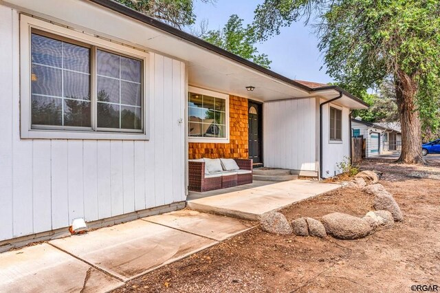 view of front facade featuring an outdoor living space and a patio area