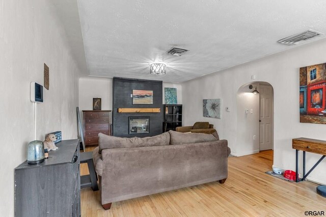 living room with a fireplace and hardwood / wood-style floors