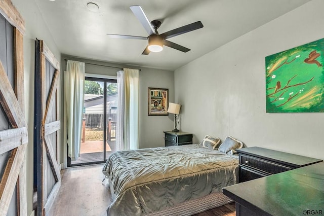 bedroom with hardwood / wood-style flooring, access to outside, and ceiling fan