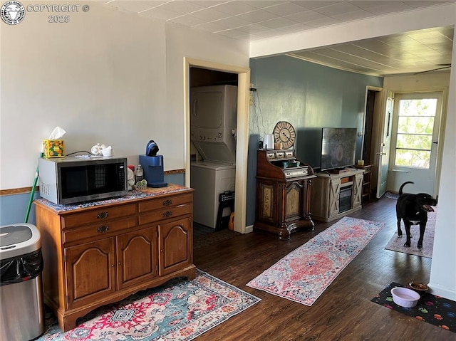 529 W Main St, Florence, CO 81226 - living area featuring stacked washer / drying machine and dark wood-type flooring