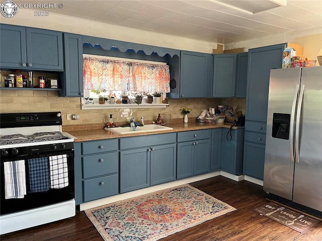 529 W Main St, Florence, CO 81226 - kitchen featuring stainless steel fridge with ice dispenser, gas stove, blue cabinets, and dark wood-type flooring