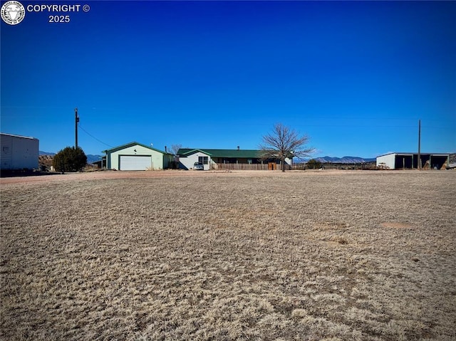 view of yard featuring a detached garage and a mountain view