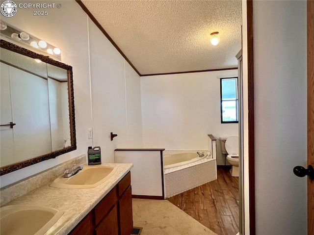 full bath featuring toilet, ornamental molding, a sink, wood finished floors, and a bath