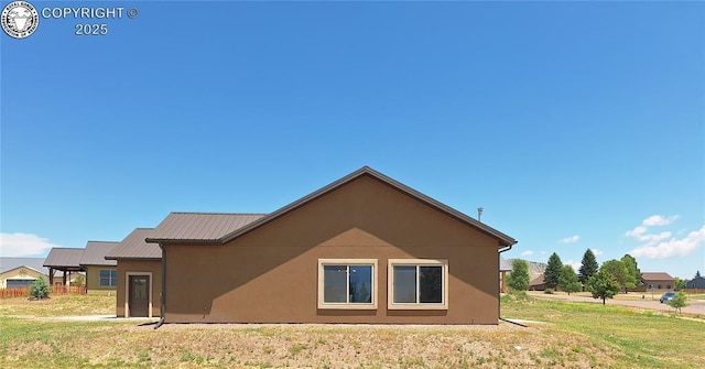 201 Fox Run, Silver Cliff, CO 81252 - view of property exterior with stucco siding, a yard, and a metal roof