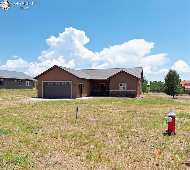 201 Fox Run, Silver Cliff, CO 81252 - single story home with a metal roof, a garage, a front yard, and stucco siding