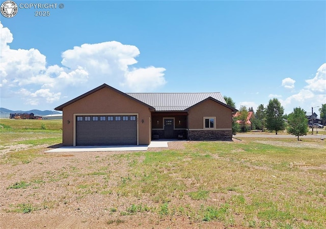 201 Fox Run, Silver Cliff, CO 81252 - view of front of house featuring stone siding, stucco siding, an attached garage, and a front yard