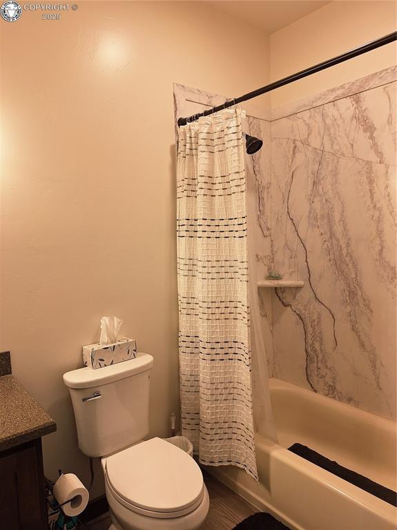 201 Fox Run, Silver Cliff, CO 81252 - bathroom featuring shower / bath combo with shower curtain and vanity