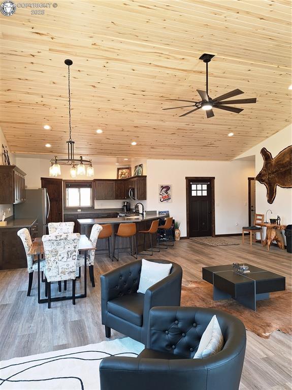 201 Fox Run, Silver Cliff, CO 81252 - living room featuring light wood-style flooring, a ceiling fan, recessed lighting, and wood ceiling