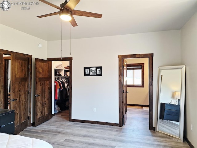 201 Fox Run, Silver Cliff, CO 81252 - unfurnished bedroom with wood finished floors, a walk in closet, and ceiling fan