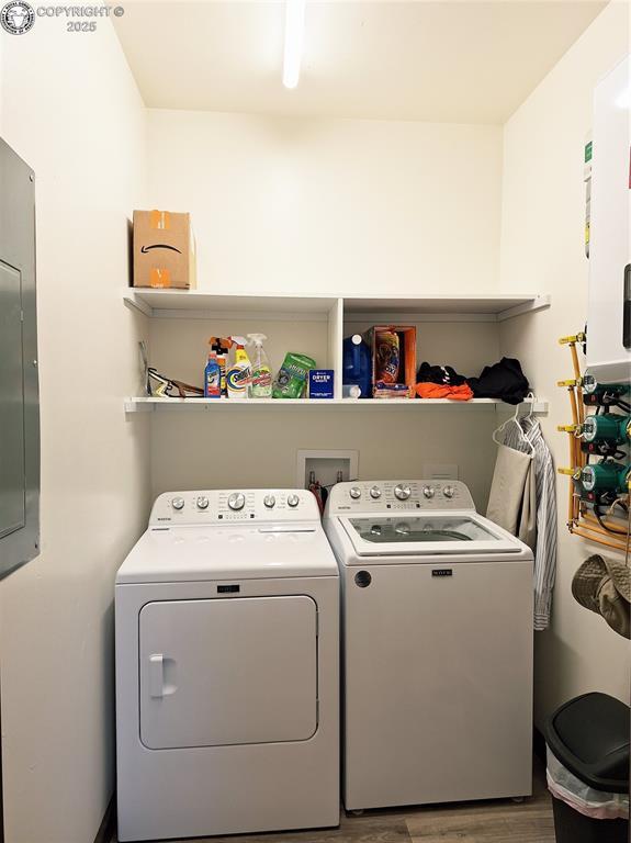 201 Fox Run, Silver Cliff, CO 81252 - laundry room featuring separate washer and dryer, wood finished floors, electric panel, and water heater