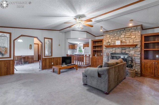 407 Horseshoe Dr, Canon City, CO 81212 - living room featuring lofted ceiling, a textured ceiling, ceiling fan, ornamental molding, and a stone fireplace