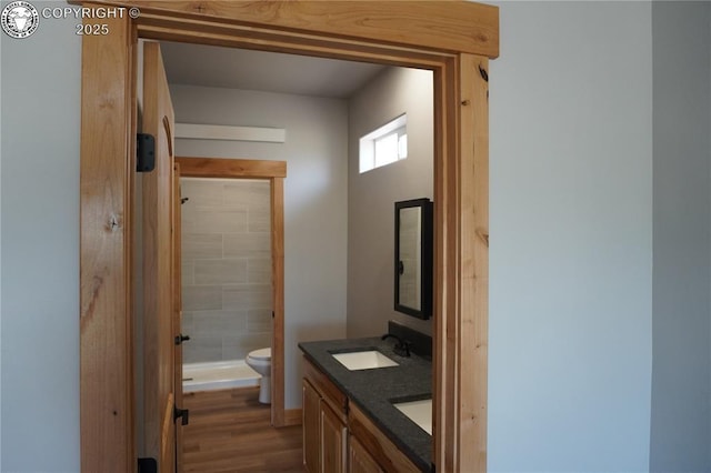 197 High Meadows Dr, Florence, CO 81226 - full bathroom featuring toilet, a shower stall, double vanity, and wood finished floors