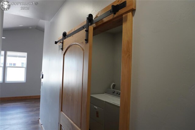 197 High Meadows Dr, Florence, CO 81226 - washroom with a barn door, wood finished floors, separate washer and dryer, and baseboards