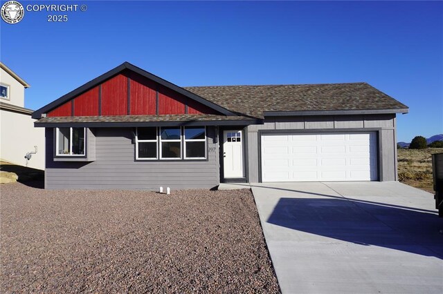 197 High Meadows Dr, Florence, CO 81226 - view of front of house featuring an attached garage, concrete driveway, and roof with shingles