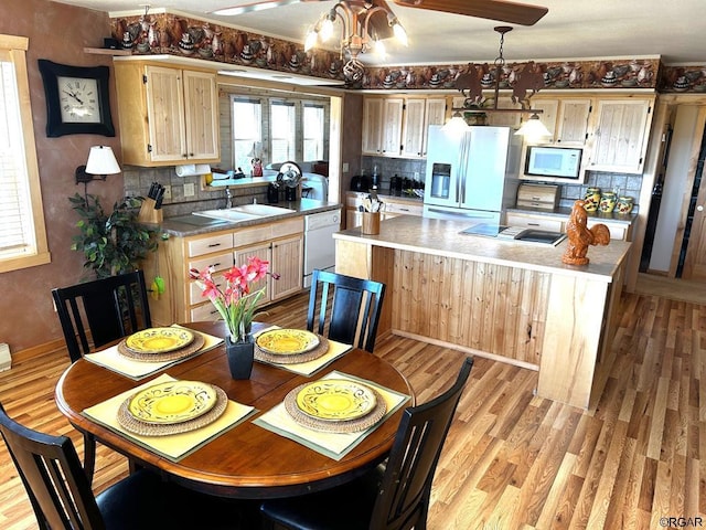 2 Inverness Ave, Westcliffe, CO 81252 - kitchen with white appliances, a sink, backsplash, a center island, and light wood-style flooring