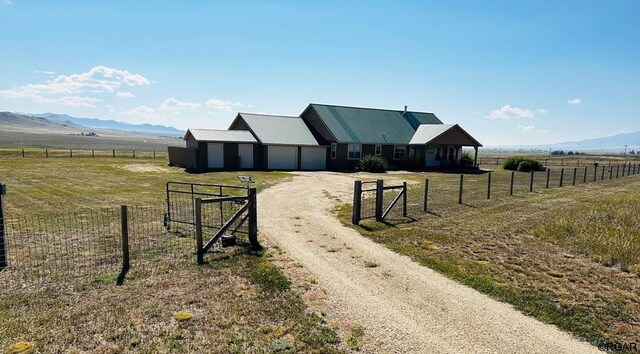 2 Inverness Ave, Westcliffe, CO 81252 - view of dirt / gravel driveway featuring a view of rural / pastoral area, a mountain view, and a gated entry